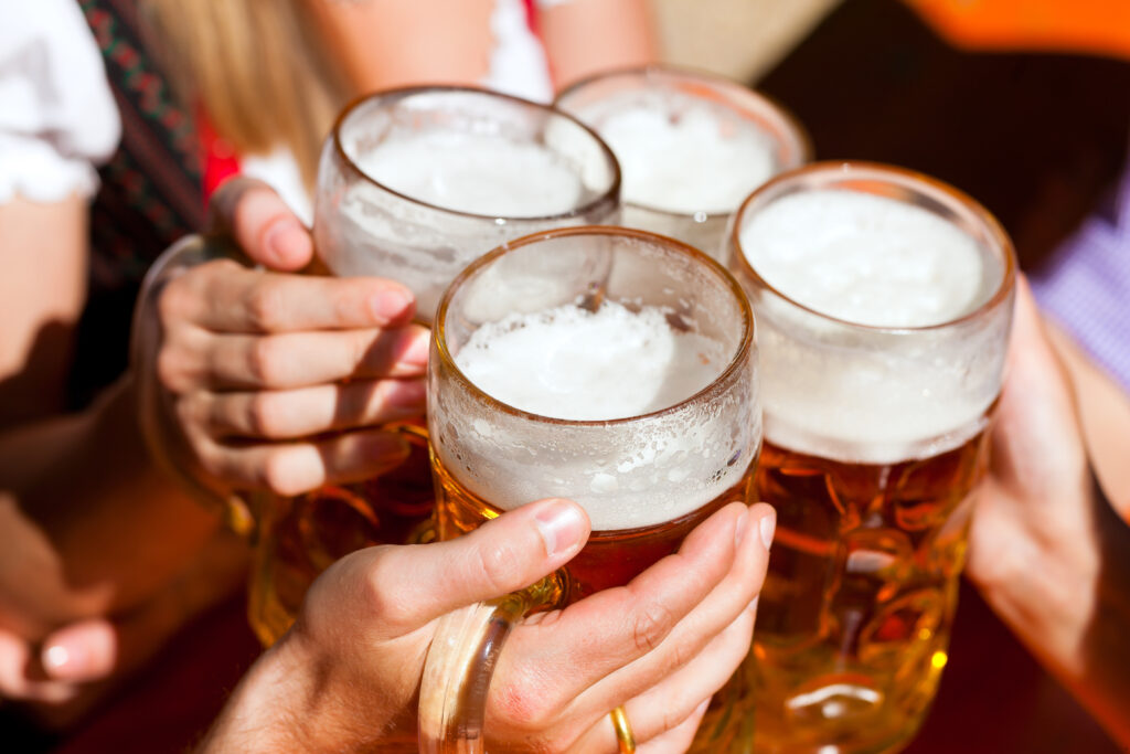 Friends make a toast and clink beer glasses